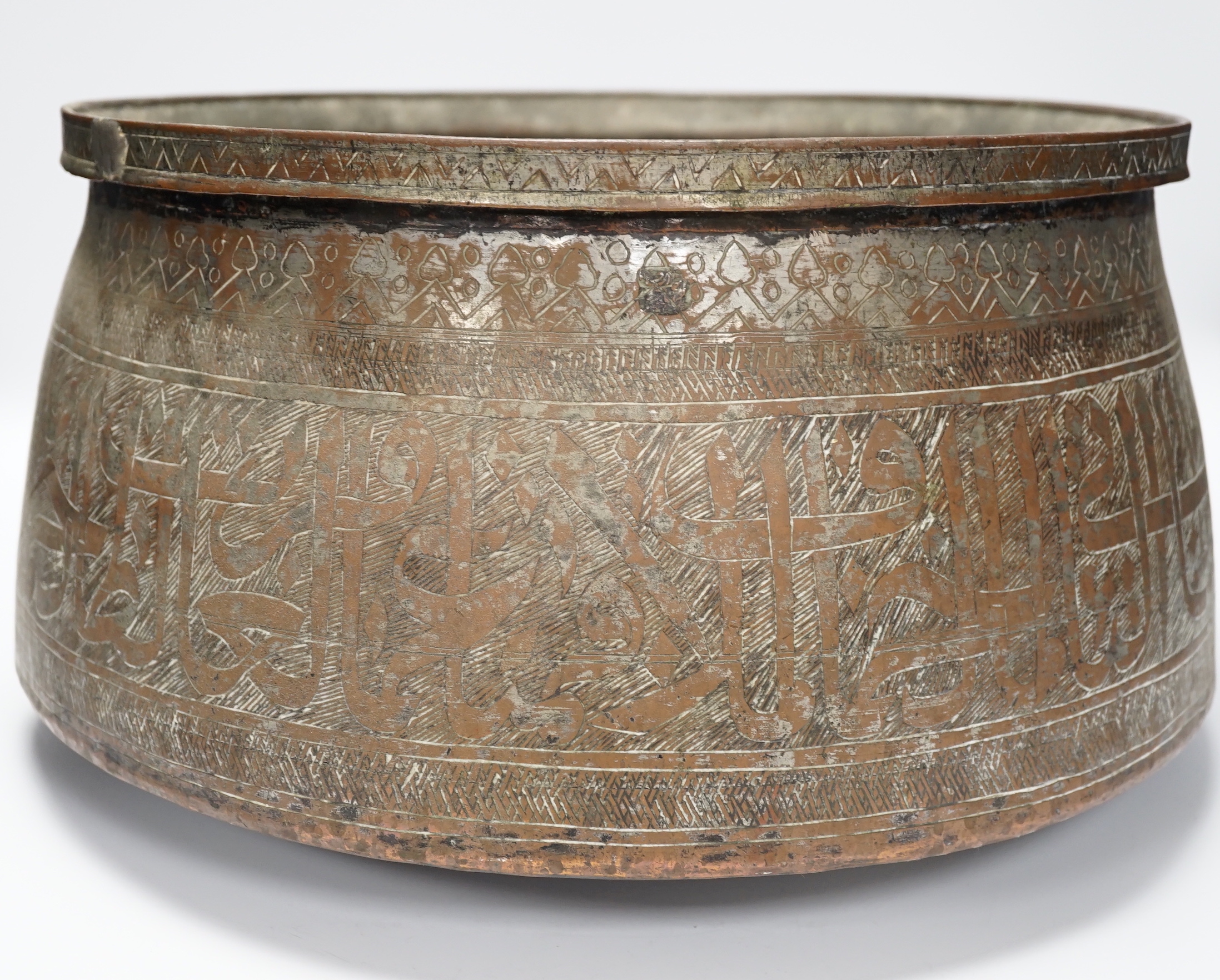 A large Islamic tinned copper bowl, inscribed in Kufic script, 38cm diameter